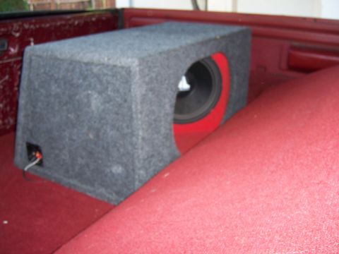 1991 Ford Bronco - A close-up view of an aftermarket subwoofer installed in the rear of a vehicle.