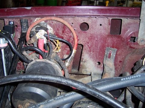1991 Ford Bronco - The engine bay shows a complex network of wires and hoses, including a Goodyear heater hose.