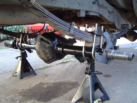 1978 Ford Bronco - Close-up of a vehicle's rear axle assembly, supported by jack stands.
