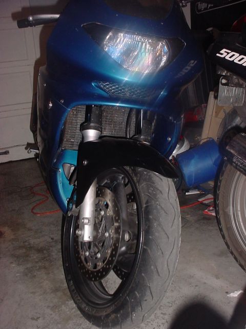 2004 Yamaha FZR600 - Front view of a blue motorcycle with a black fender and dual headlights, parked next to another motorcycle.