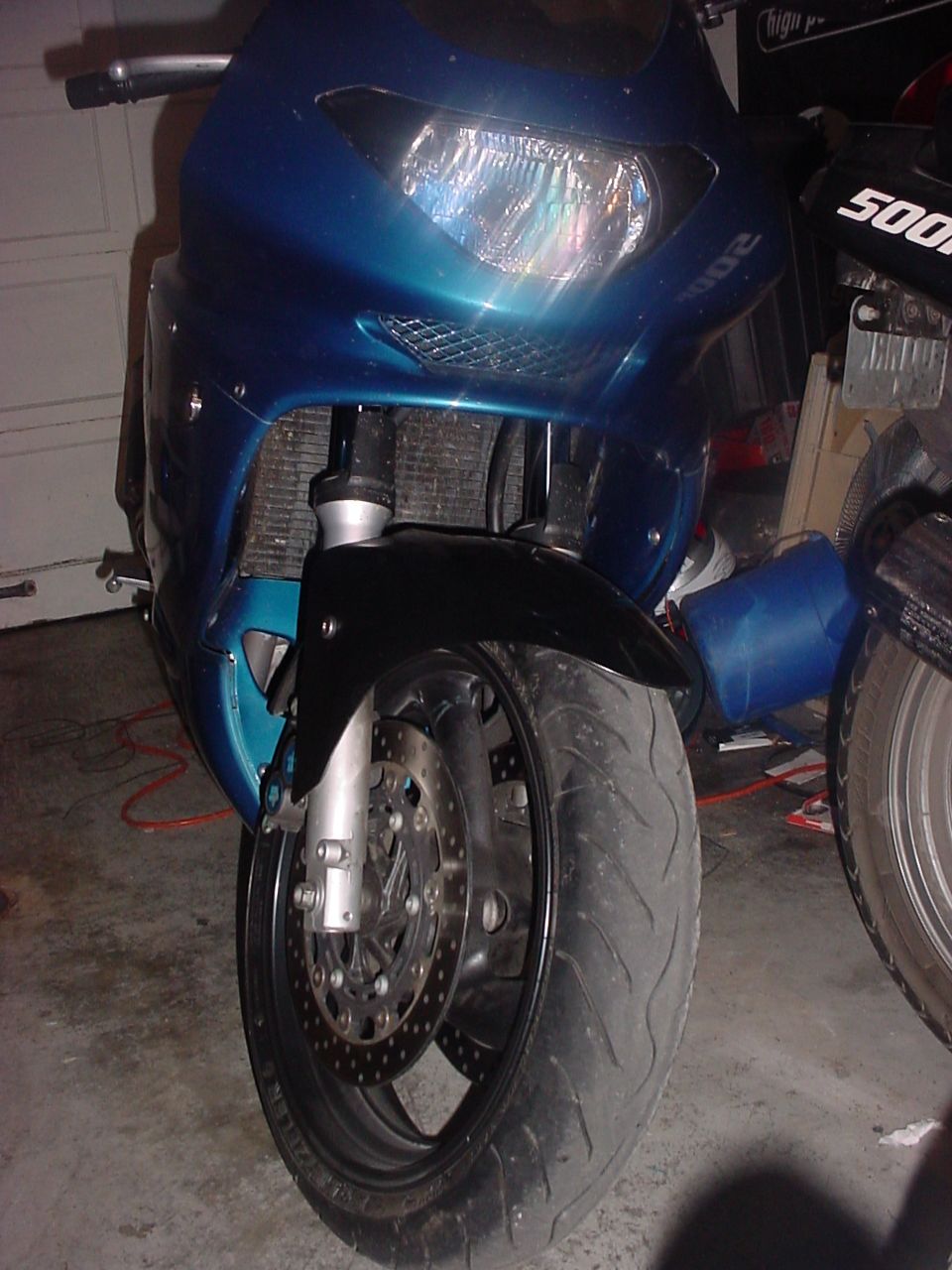 Blue Yamaha sportbike front end with shortened black fender and drilled brake rotor