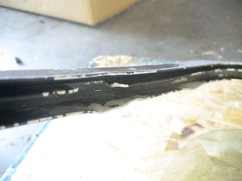 1993 Ford C-350 (Centurion Conversions) - The paint is chipped and peeling on this vehicle's window frame, revealing damage underneath.