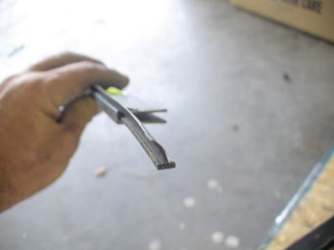 1993 Ford C-350 (Centurion Conversions) - A hand holds a flathead screwdriver, its tip angled towards the viewer.