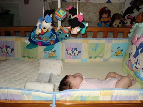 2000 Ford Crown Victoria - A baby sleeps soundly in a crib adorned with Disney characters.