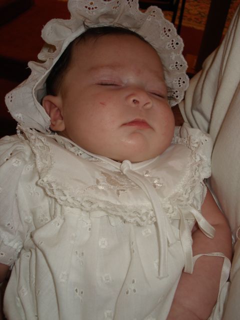 2000 Ford Crown Victoria - Baby sleeping peacefully in a traditional christening gown and bonnet.