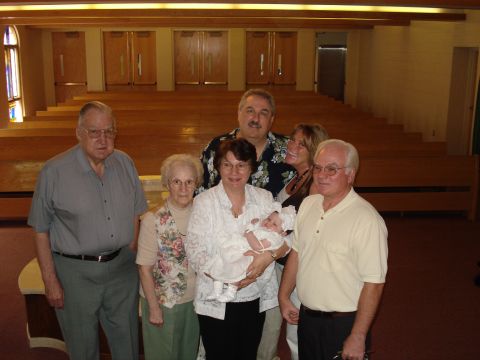2000 Ford Crown Victoria - A family gathers for a photo, holding a baby dressed in white.
