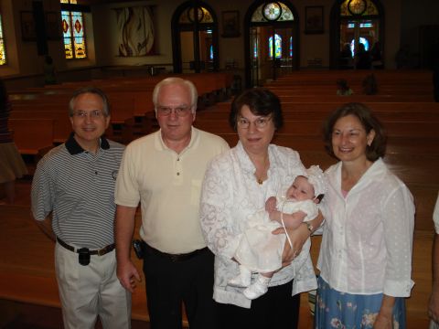 2000 Ford Crown Victoria - A family poses for a photograph in a church, likely during a baptism or christening ceremony.