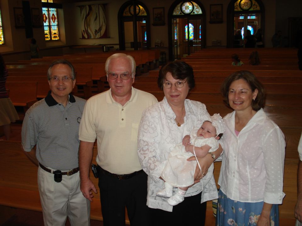 Family posing for a photo inside a church