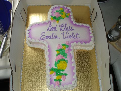 2000 Ford Crown Victoria - A cross-shaped cake with floral decorations and a personalized message is presented in a box.