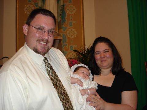 2000 Ford Crown Victoria - A family poses for a photo, likely during a christening ceremony.