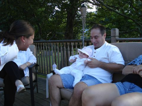 2000 Ford Crown Victoria - A family gathers on an outdoor deck on a sunny day.
