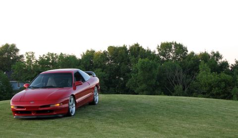 1993 Ford Probe - A red 1993 Ford Probe is shown from a three-quarter front view on a grassy knoll.