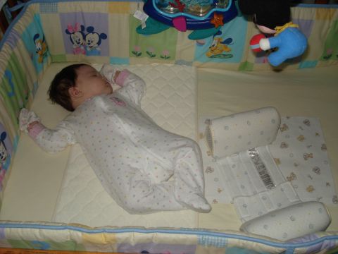 2000 Ford Crown Victoria - A baby sleeps soundly in a crib adorned with cartoon characters.