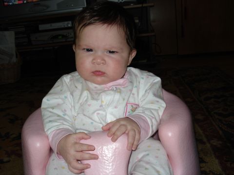 2000 Ford Crown Victoria - A baby sits in a pink seat, wearing pajamas with hearts and bunnies.