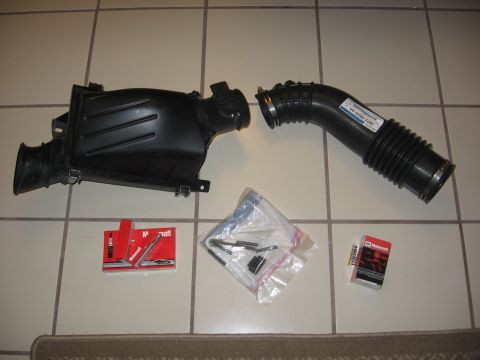 2000 Ford Crown Victoria - Motorcraft air intake components laid out on a tiled surface.
