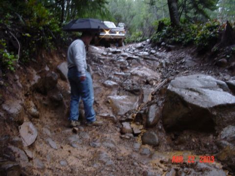 1989 Ford Bronco - Have to fit by this rock on the slippery downhill