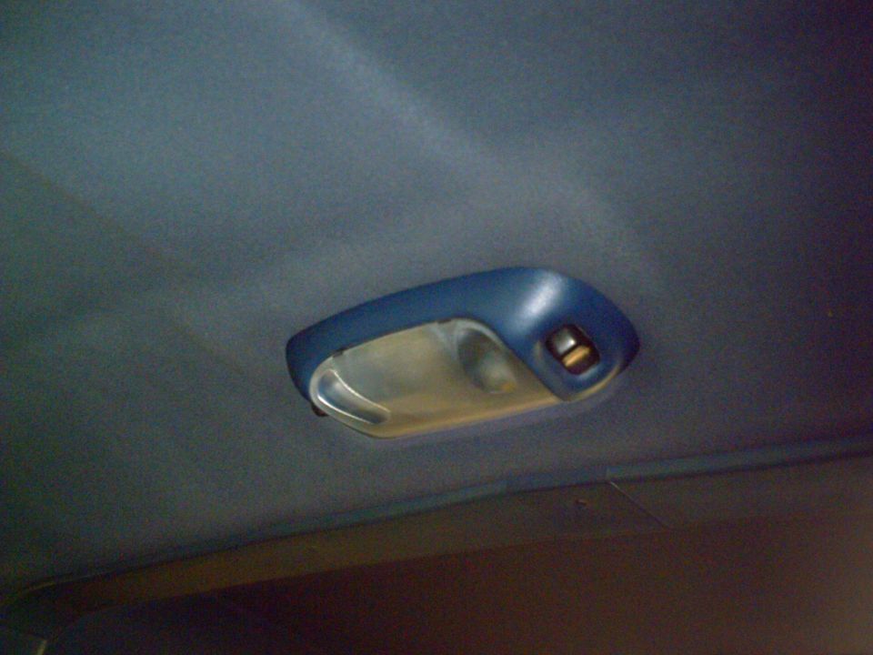 Interior dome light assembly on a blue headliner