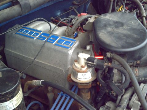 1990 Ford Bronco - Close-up of a Ford engine intake manifold, showing the 'Ford' branding and various engine parts.