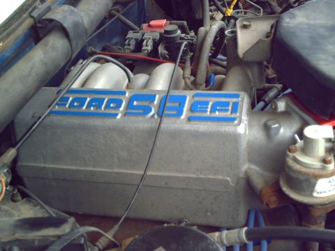 1990 Ford Bronco - Close-up of a Ford 5.8L EFI engine valve cover, indicating the engine type.