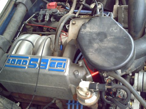 1990 Ford Bronco - The engine bay shows a Ford 5.8L EFI engine with visible wiring and hoses.