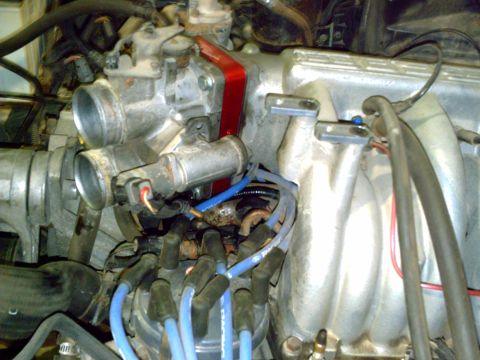 1990 Ford Bronco - Engine intake manifold and throttle body assembly with distributor and spark plug wires visible.