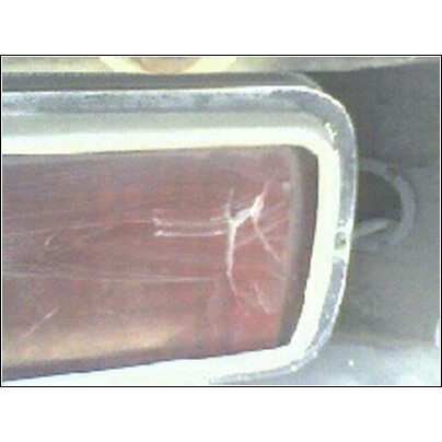 1973 Ford Ranchero - Close-up of a damaged tail light assembly, showing cracks in the lens.