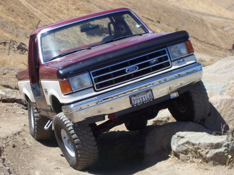 1991 Ford Bronco - This two-tone Ford Bronco navigates rocky terrain, its off-road capabilities.