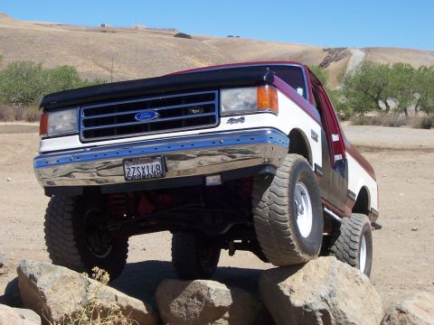 1991 Ford Bronco - 1991 Ford Bronco with lifted suspension navigating rocky terrain.