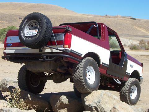 1991 Ford Bronco - This 1991 Ford Bronco is shown in a three-quarter front view as it navigates rocky terrain.