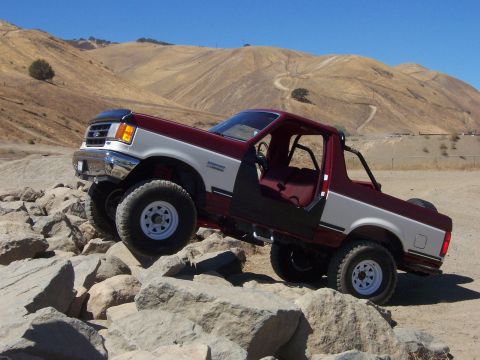 1991 Ford Bronco - This 1991 Ford Bronco is navigating a rocky obstacle course under a clear blue sky.