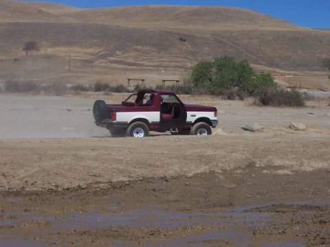 1991 Ford Bronco - This 1991 Ford Bronco is stuck in the mud with its doors open.