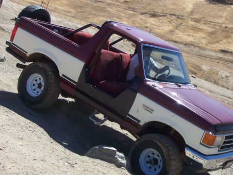 1991 Ford Bronco - This 1991 Ford Bronco is shown off-roading on a dirt incline.