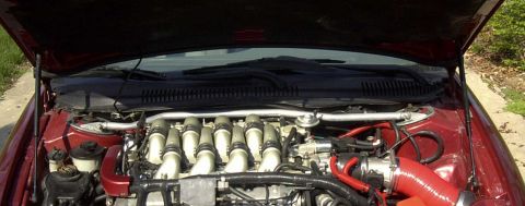 1997 Ford Taurus - The engine bay of a 1997 Ford Taurus is visible with the hood raised.