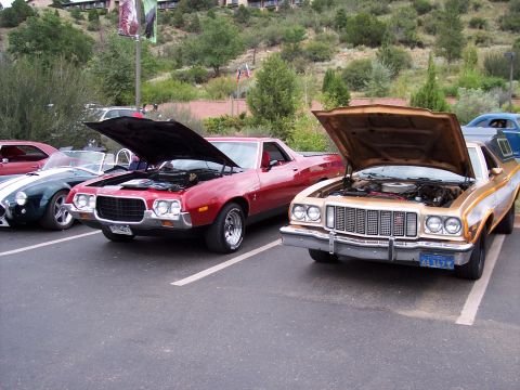 1972 Ford Ranchero - Two Ford Rancheros, a red and a tan model, are parked with their hoods open at a car show.