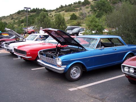 1972 Ford Ranchero - A blue 1966 Chevrolet Nova coupe is displayed with its hood open at a car show, alongside other vehicles.