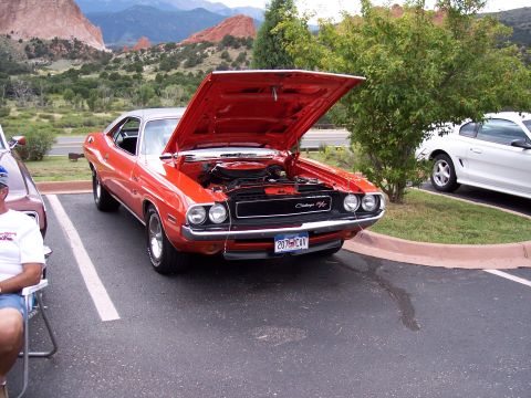 1972 Ford Ranchero - An orange 1970 Dodge Challenger R/T is parked with its hood open, with a white car visible to the right.