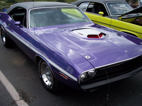 1972 Ford Ranchero - A purple Dodge Challenger is parked next to a yellow car.
