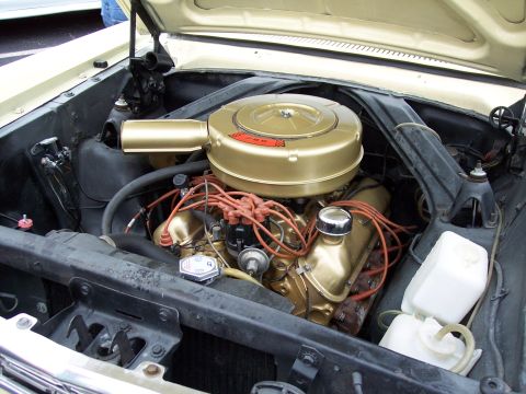 1972 Ford Ranchero - The engine bay of a classic car is shown with its hood open, revealing the engine components.