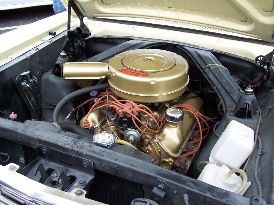 Engine bay with gold air cleaner and valve covers, orange spark plug wires