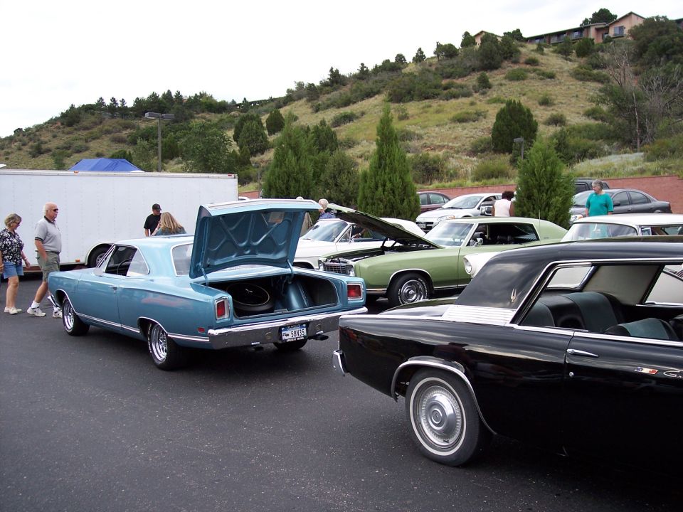 Blue 1969 Plymouth GTX coupe with open trunk, showing spare tire