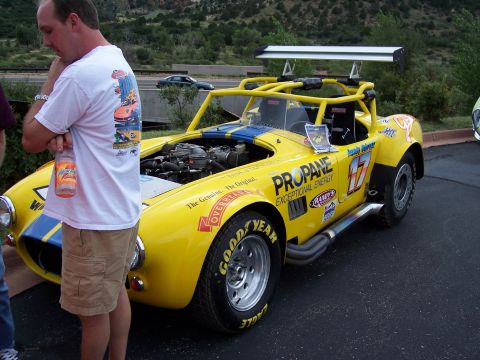 1972 Ford Ranchero - This yellow race car features prominent racing decals and an exposed engine bay.