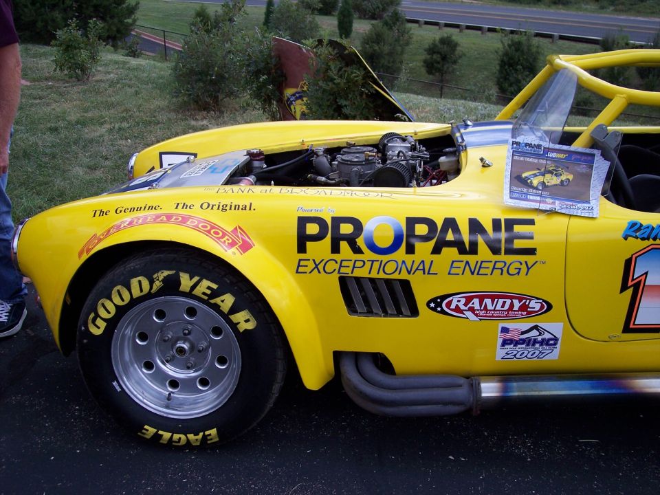 Yellow race car with "PROPANE EXCEPTIONAL ENERGY" text and Goodyear tires