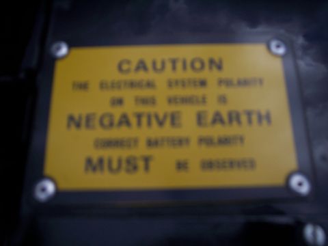 1972 Ford Ranchero - A yellow caution plate reads 'The electrical system polarity on this vehicle is negative earth. Correct battery polarity must be observed.'