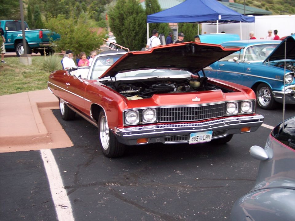 Red 1971 convertible with hood open, showing engine and chrome grille. License plate reads 405 LHR