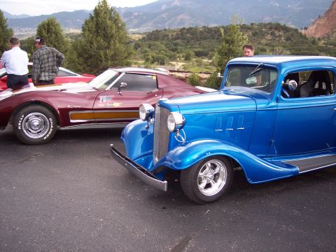 1972 Ford Ranchero - Two classic cars are parked outdoors with a scenic mountain view behind them.
