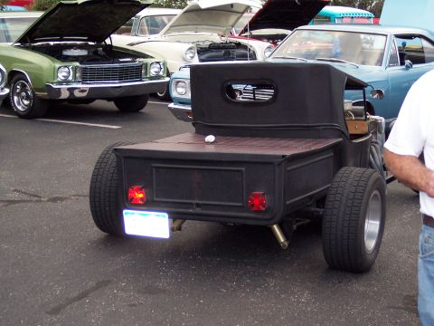 1972 Ford Ranchero - A custom hot rod pickup truck is parked among other vehicles with their hoods open.