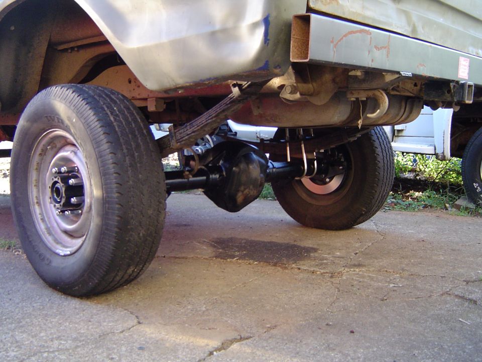 Rear axle assembly with leaf springs and tires on concrete