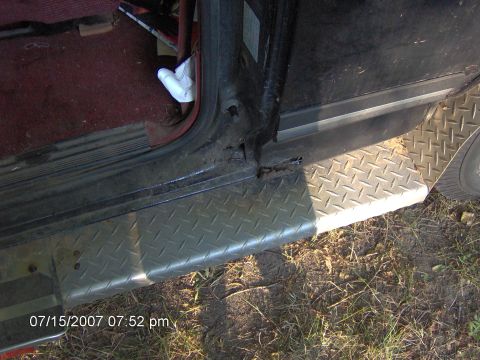 1987 Ford Bronco - Close-up view of a vehicle's interior door sill and running board, showing some rust.