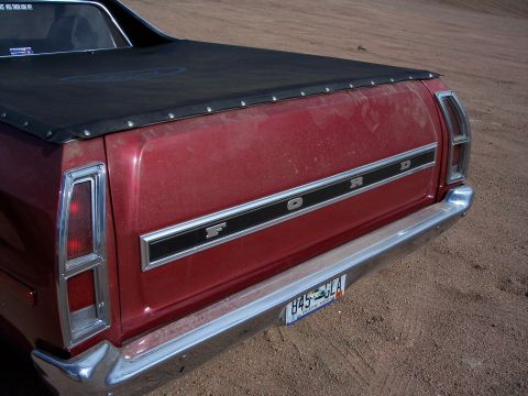 1972 Ford Ranchero - Rear view of a red 1972 Ford Ranchero pickup truck, showing the tailgate, taillights, and chrome bumper.