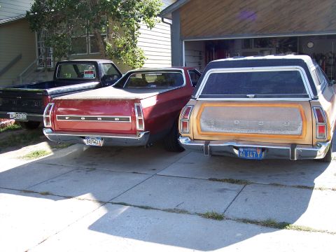 1972 Ford Ranchero - Rear view of a red Ford Ranchero and a tan Ford Country Squire wagon parked in a driveway.